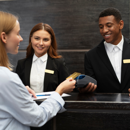A woman dressed in a blue shirt and a black blazer, embodying a professional look in travel and hospitality.